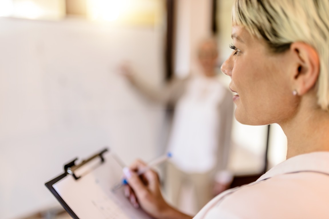 Woman with vision making notes during In2Learning training